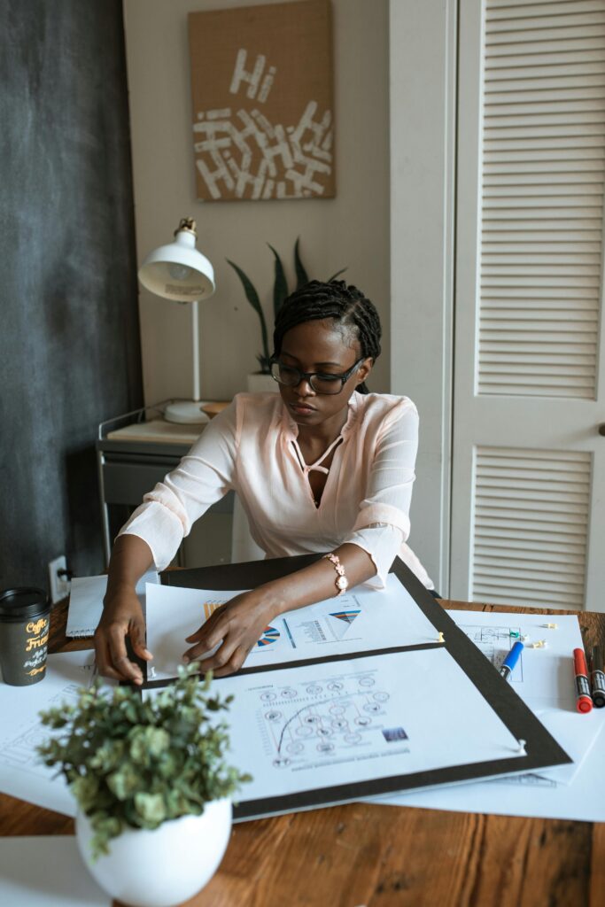 Photo Of Woman Working On White Paper